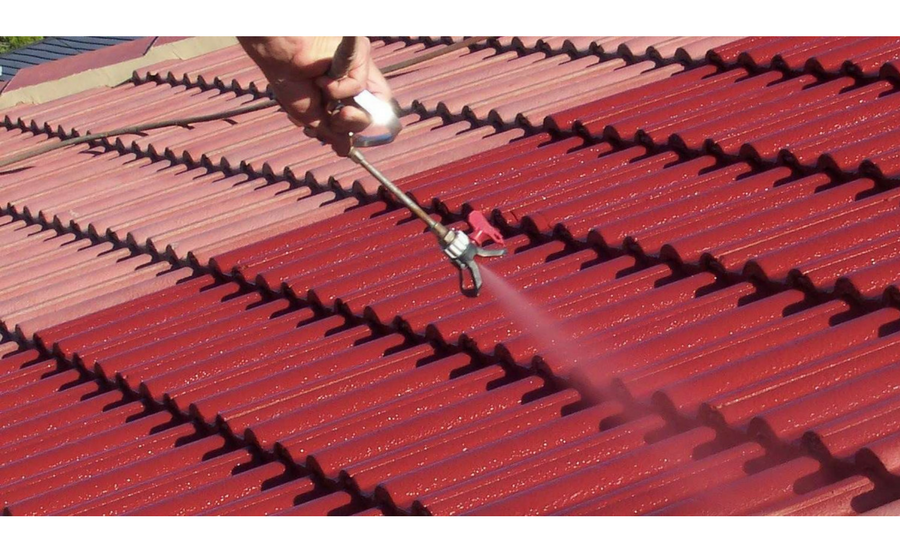 man painting and cleaning roof in Nanaimo